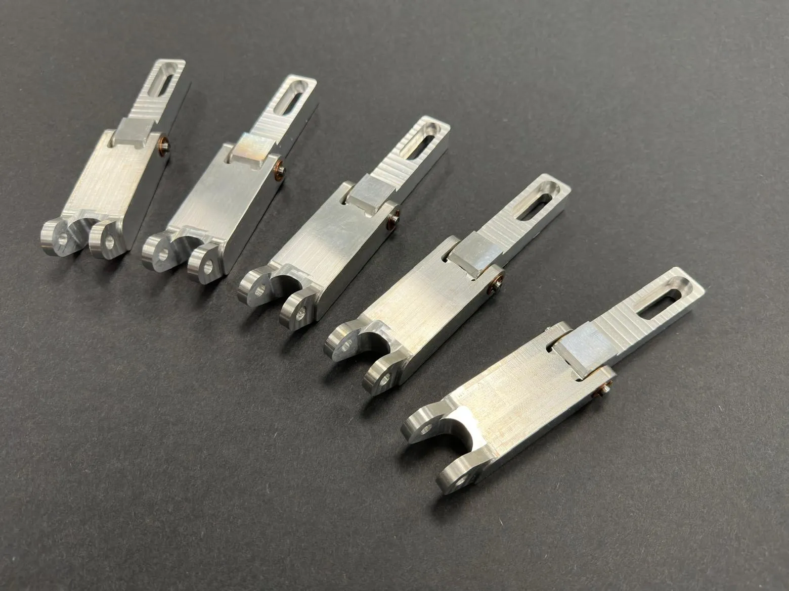 Five assembled hinges laid out.