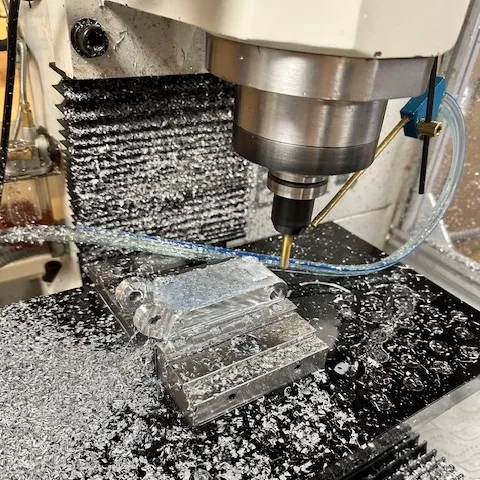 Machining a part of the hinge.